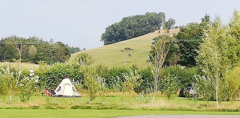 tepee tent and hills 768x380